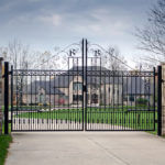 victorian metal entry gate with custom monogram initials and custom triangular archtop