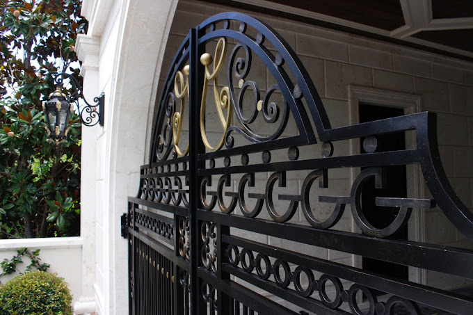 victorian style metal gate with fancy inlay monograms