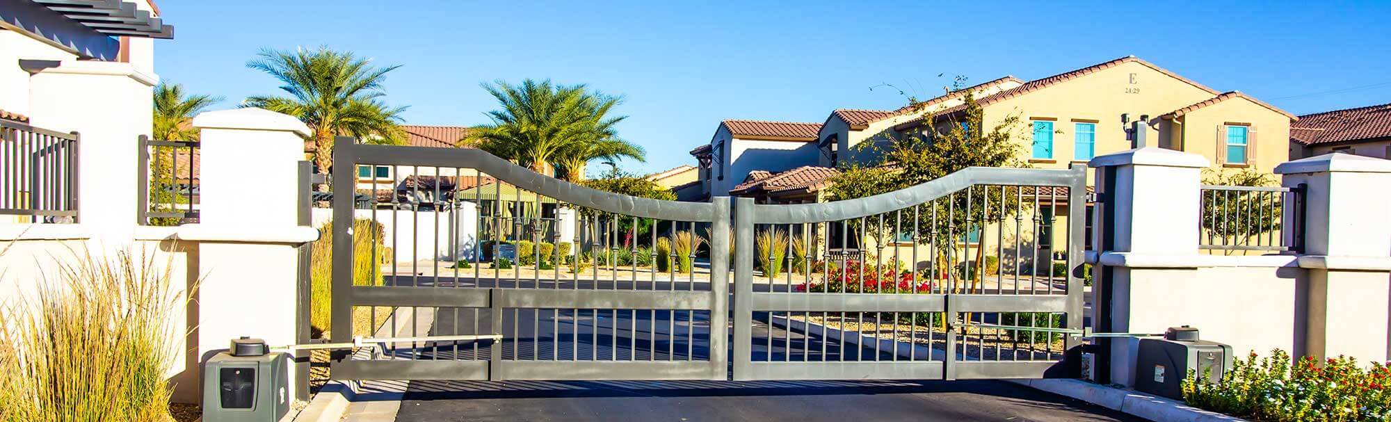 Automated HOA community gate entry with dual swing gates and gate operators serving a residential neighborhood in Lakewood Ranch, FL