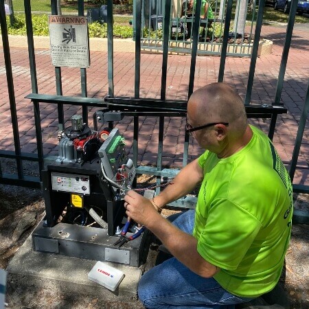 Sarasota Gate & Access technician servicing a gate operator on-site in Manatee County, FL