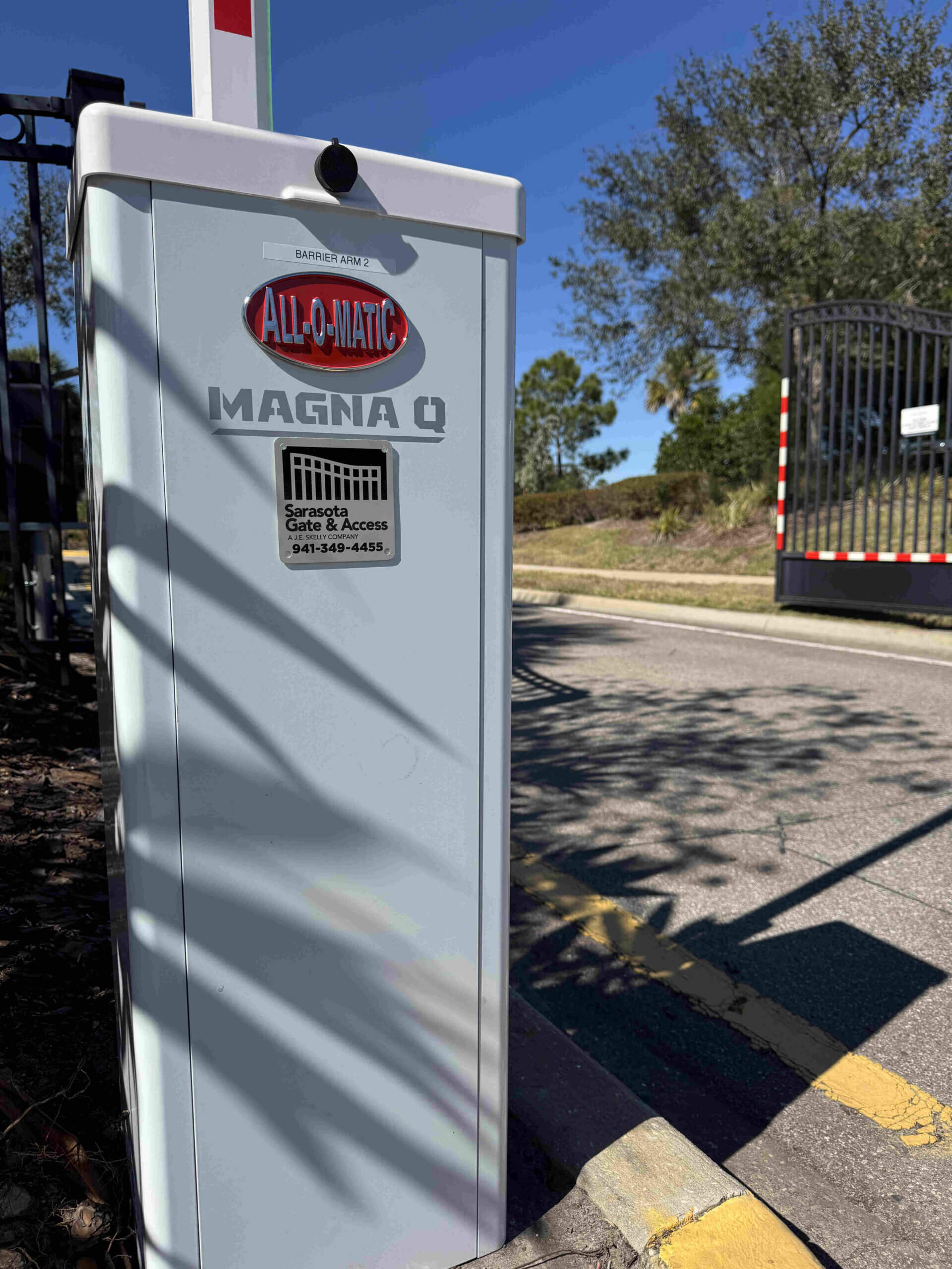 All-O-Matic Magna Q barrier arm operator installed at an HOA community gate entry in Sarasota, FL by Sarasota Gate & Access