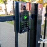 HOA gate keypad and intercom access control panel mounted on black iron fence in Sarasota, FL