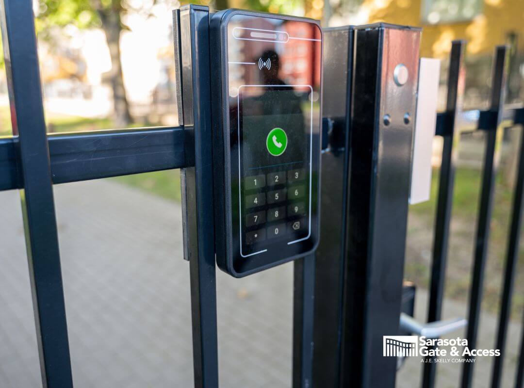 HOA gate keypad and intercom access control panel mounted on black iron fence in Sarasota, FL