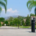 Automated ornamental iron dual swing gate with gate operator at a gated HOA community entry in Sarasota, FL