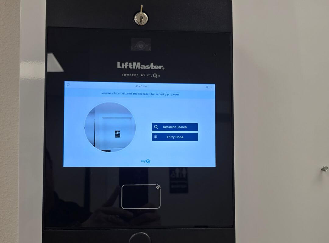 LiftMaster myQ video intercom touchscreen panel with resident search and entry code access installed at an HOA community gate in Sarasota, FL