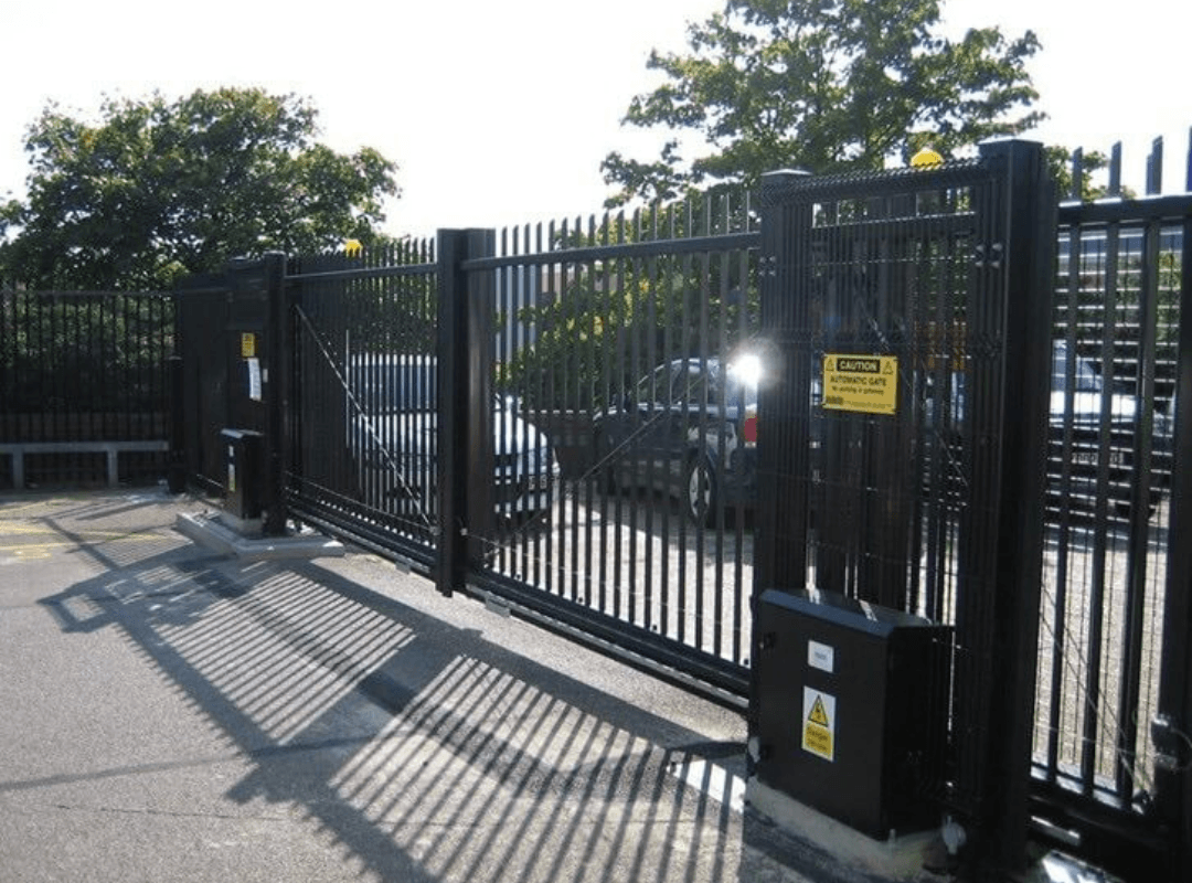 Commercial Automated Sliding Gate Installation Heavy-duty commercial automated sliding gate with gate operator and caution signage installed at a commercial property — the type of commercial gate installation Sarasota Gate & Access delivers for business owners and property managers