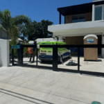 Sarasota Gate & Access technicians installing a modern aluminum sliding driveway gate at a luxury residential property in Fort Myers, FL