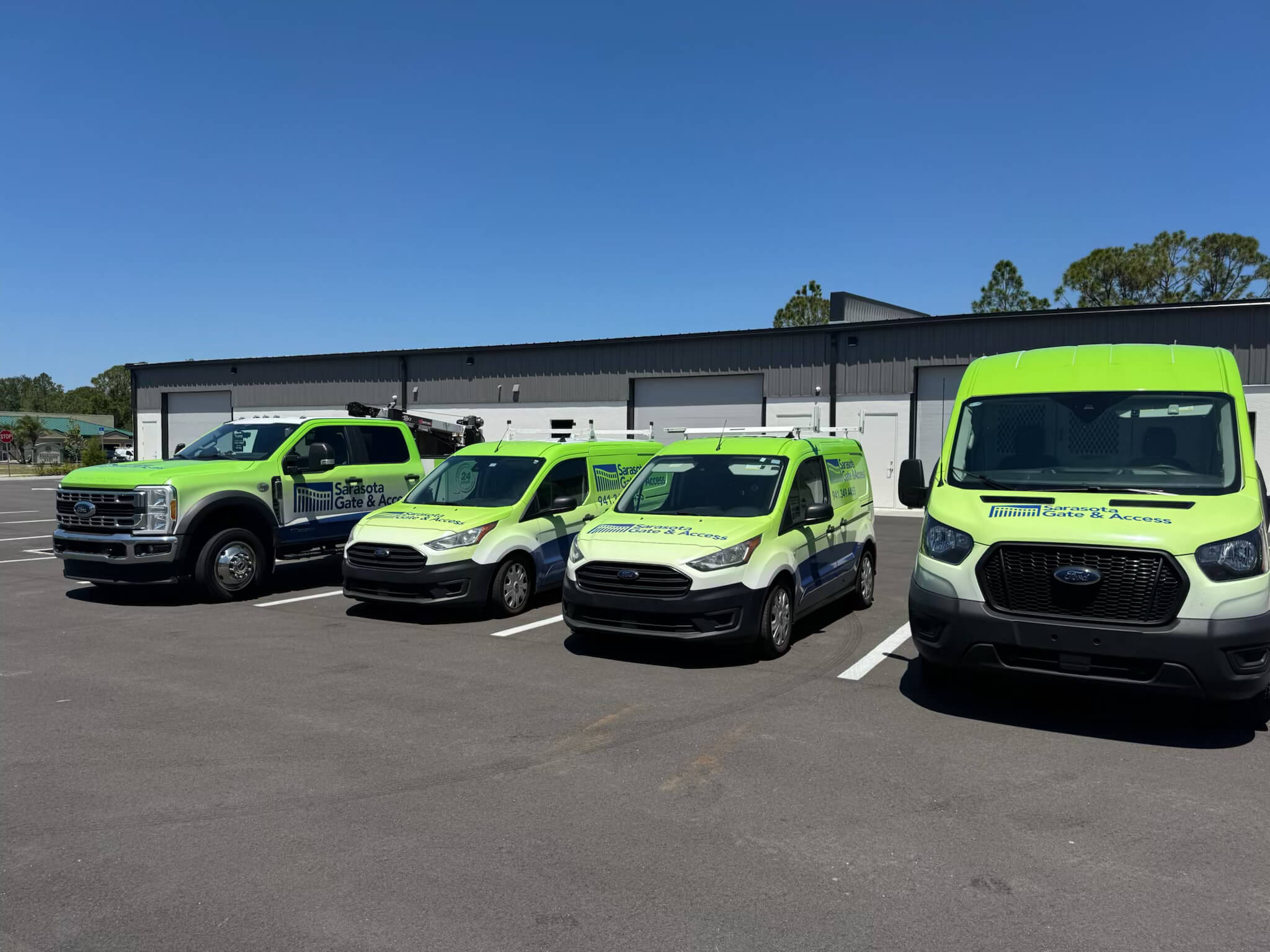 Sarasota Gate & Access - Vendor-Credentialed Gate Company Serving Sarasota & Bradenton Sarasota Gate & Access full service fleet lined up outside the Bradenton facility — a vendor-credentialed gate company verified on VendorShield, RealPage, Net Vendor, Vive, Vendor Cafe, and Revyse