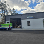 Sarasota Gate & Access facility in Bradenton with branded service van, LiftMaster dealer signage, and on-site parts warehouse serving commercial gate installations in Fort Myers and Southwest Florida