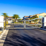 Automated dual swing gate with gate operators at an HOA community entry in Sarasota, FL, the type of access control system Sarasota Gate & Access installs and maintains