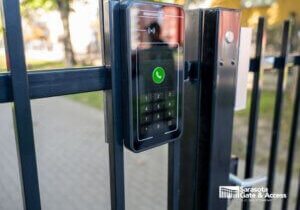 HOA gate keypad and intercom access control panel mounted on black iron fence in Sarasota, FL