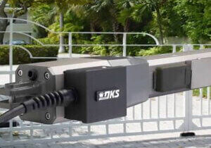 DoorKing DKS barrier arm gate operator mounted on a commercial gate system at an HOA community entry in Florida