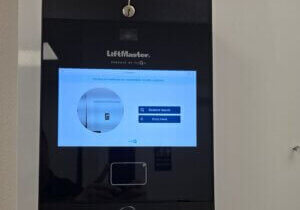 LiftMaster myQ video intercom touchscreen panel with resident search and entry code access installed at an HOA community gate in Sarasota, FL