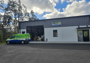 Sarasota Gate & Access facility in Bradenton with branded service van, LiftMaster dealer signage, and on-site parts warehouse serving commercial gate installations in Fort Myers and Southwest Florida